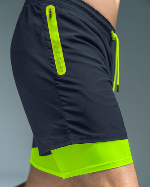 pantaloneta-deportiva-con-bolsillo-lateral-con-boxer-interno#color_536-azul-oscuro-verde-neon